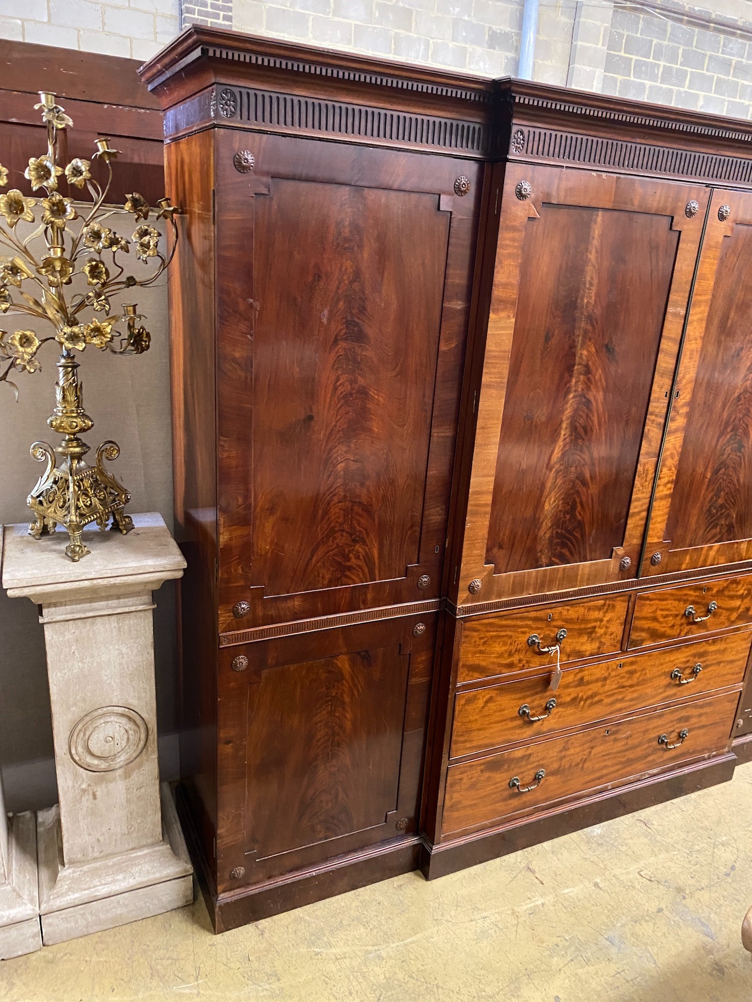 An Edwardian mahogany breakfront wardrobe, with two doors enclosing trays and four drawers flanked by hanging compartments, width 256cm, height 209cm